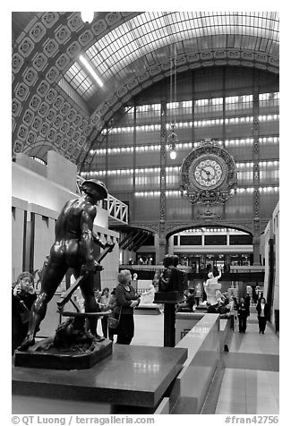 Sculpture and historic clock inside Orsay Museum. Paris, France