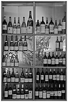 Wine bottles in storefront, passage Vivienne. Paris, France (black and white)