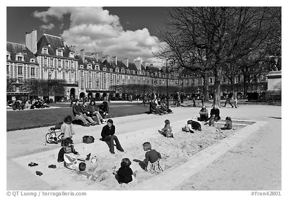 Children playing in sandbox, Place des Vosges. Paris, France