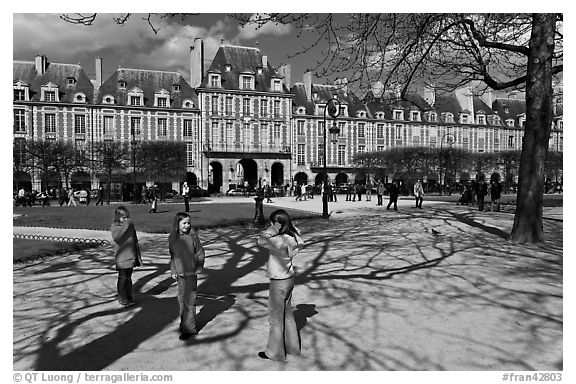 Girls playing in park, Place des Vosges. Paris, France (black and white)