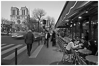 Cafe, street, and Notre Dame at dusk. Quartier Latin, Paris, France (black and white)