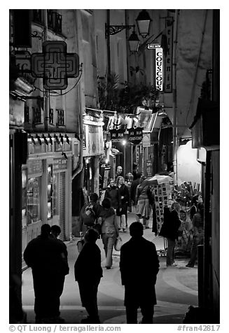 Pedestrian street with restaurants at night. Quartier Latin, Paris, France (black and white)