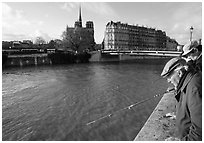 Fishermen on ile Saint Louis, with ile de la Cite in the background. Paris, France (black and white)