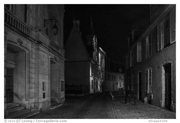 Projection on Palais Jacques Coeur and blue light in the streets. Bourges, Berry, France (black and white)