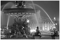 Fountain on Place de la Concorde and Assemblee Nationale by night. Paris, France ( black and white)