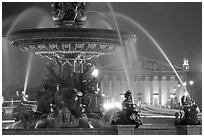 Fountain on Place de la Concorde and Assemblee Nationale by night. Paris, France (black and white)