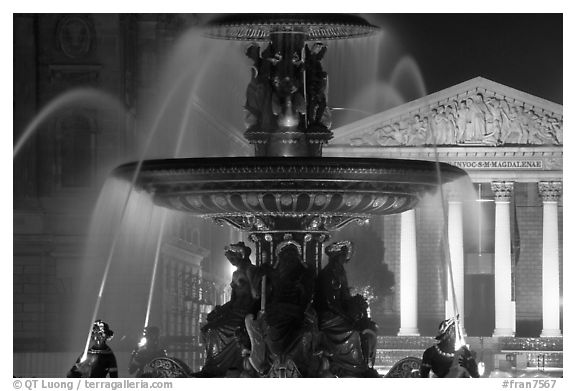 Fountain on Place de la Concorde and Madeleine church at night. Paris, France