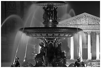 Fountain on Place de la Concorde and Madeleine church at night. Paris, France (black and white)