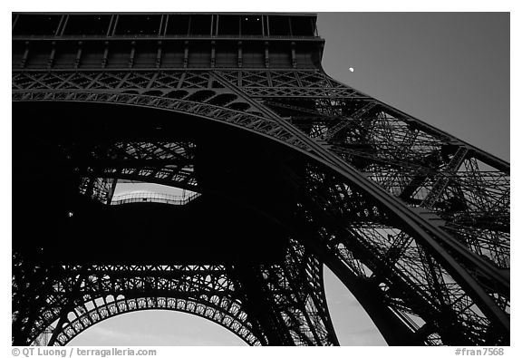 Base of Tour Eiffel (Eiffel Tower) with moon. Paris, France (black and white)