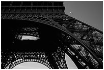 Base of Tour Eiffel (Eiffel Tower) with moon. Paris, France (black and white)