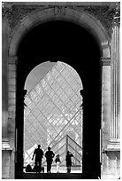 Pyramid seen through one of the Louvre's Gates. Paris, France (black and white)