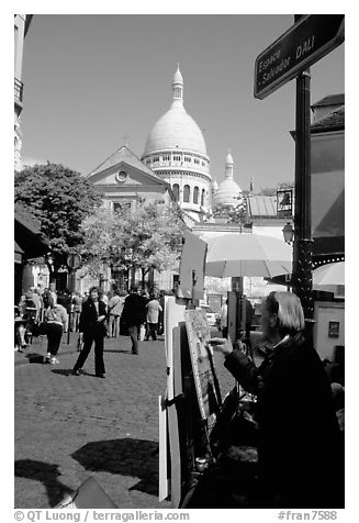 Painter on Place du Tertre, with the Sacre Coeur in the background, Montmartre. Paris, France (black and white)