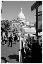 Painter on Place du Tertre, with the Sacre Coeur in the background, Montmartre. Paris, France (black and white)