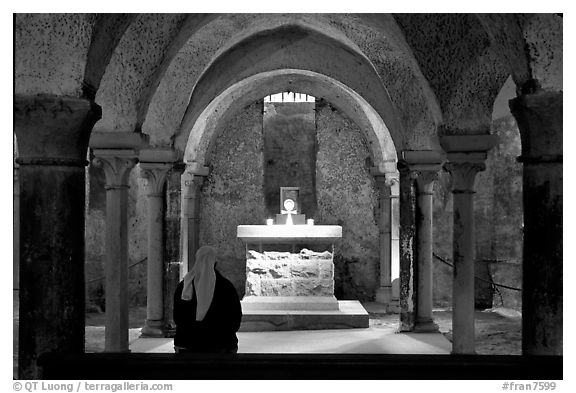 Crypte of the Romanesque church of Vezelay with Nun in prayer. Burgundy, France (black and white)