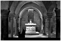 Crypte of the Romanesque church of Vezelay with Nun in prayer. Burgundy, France (black and white)