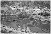 Chortens, cultivated terraces,  and village, Zanskar, Jammu and Kashmir. India (black and white)