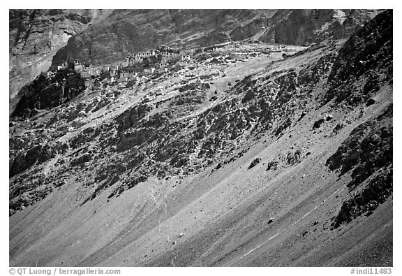 Rocky slopes topped by village and gompa, Zanskar, Jammu and Kashmir. India (black and white)