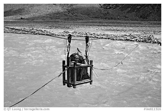 Trekker crossing a river by cable, Zanskar, Jammu and Kashmir. India (black and white)