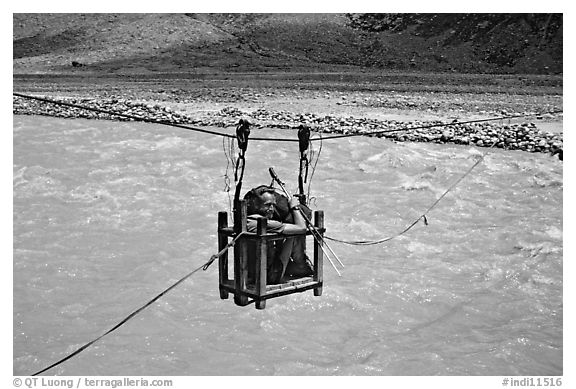 Trekker crossing a river by cable, Zanskar, Jammu and Kashmir. India