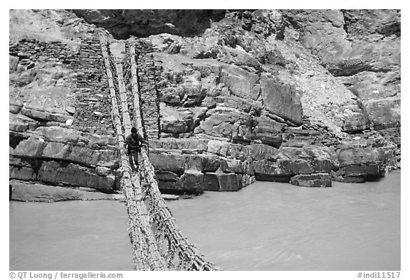 Man crossing a river by rope bridge, Zanskar, Jammu and Kashmir. India (black and white)