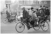 Cycle-rickshaw with a load of ten schoolchildren. New Delhi, India ( black and white)