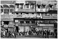 Street with many people waiting in front of closed stores, Old Delhi. New Delhi, India (black and white)