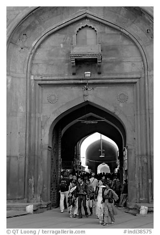 People walking out of the Covered Bazar, Red Fort. New Delhi, India (black and white)