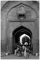 People walking out of the Covered Bazar, Red Fort. New Delhi, India (black and white)