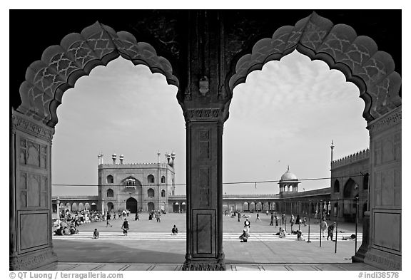 Courtyard of mosque seen through arches of prayer hall, Jama Masjid. New Delhi, India (black and white)