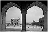 Courtyard of mosque seen through arches of prayer hall, Jama Masjid. New Delhi, India (black and white)