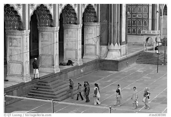 Women in colorful sari walking towards prayer hall, Jama Masjid. New Delhi, India