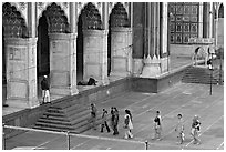 Women in colorful sari walking towards prayer hall, Jama Masjid. New Delhi, India (black and white)