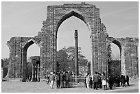 Iron pillar, and ruined mosque arch, Qutb complex. New Delhi, India (black and white)