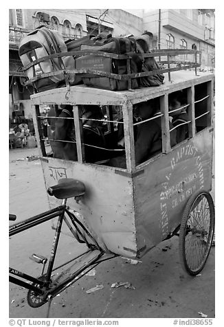 Schoolchildren in an enclosed  box towed by cycle. New Delhi, India (black and white)