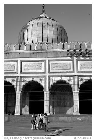 Group of people walking out of prayer hall. New Delhi, India (black and white)