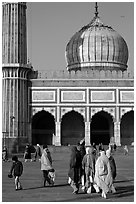Group of people, courtyard, prayer hall, and dome, Jama Masjid. New Delhi, India (black and white)