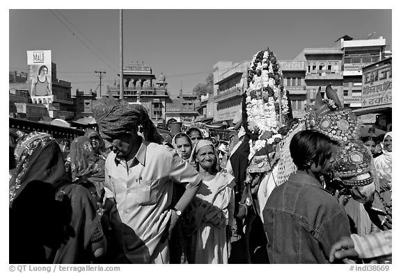 Groom covered in flowers and riding horse during Muslim wedding. Jodhpur, Rajasthan, India (black and white)