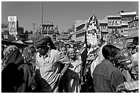 Groom covered in flowers and riding horse during Muslim wedding. Jodhpur, Rajasthan, India ( black and white)