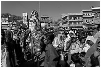 Wedding procession with flower-covered groom on horse. Jodhpur, Rajasthan, India ( black and white)