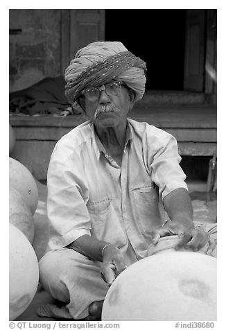 Man with turban holding a jar. Jodhpur, Rajasthan, India