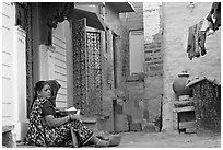 Women sitting in alley painted with indigo tinge. Jodhpur, Rajasthan, India ( black and white)