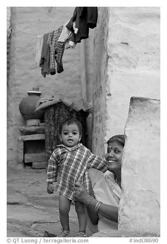 Baby girl and woman in blue alley. Jodhpur, Rajasthan, India