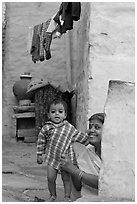 Baby girl and woman in blue alley. Jodhpur, Rajasthan, India (black and white)