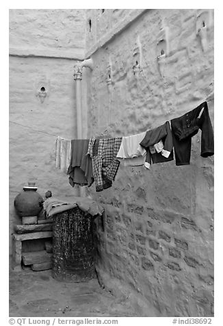 Laundry in alley with whitewashed walls tinted indigo. Jodhpur, Rajasthan, India (black and white)