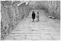 Children walking on the stone ramp leading to the fort. Jodhpur, Rajasthan, India ( black and white)