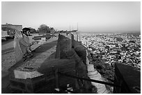 Couple looking at the view from Mehrangarh Fort. Jodhpur, Rajasthan, India (black and white)