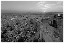 Mehrangarh Fort walls, blue houses, and setting sun. Jodhpur, Rajasthan, India ( black and white)