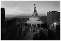 Chamunda Devi temple with man worshipping at sunset, Mehrangarh Fort. Jodhpur, Rajasthan, India (black and white)