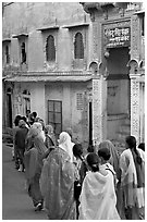 Women walking in a narrow old town street. Jodhpur, Rajasthan, India (black and white)