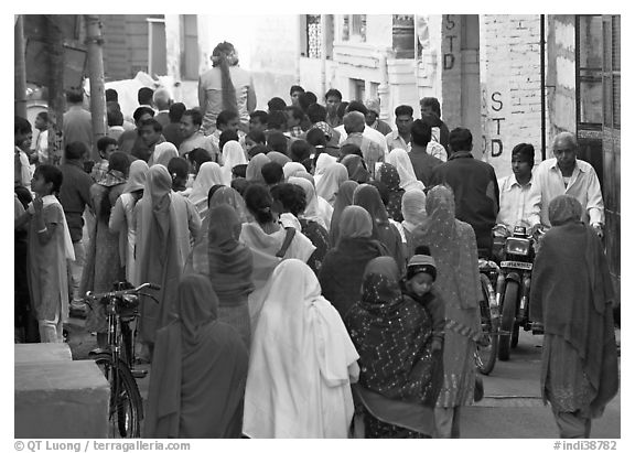 Women in colorful sari in a narrow street during wedding. Jodhpur, Rajasthan, India (black and white)